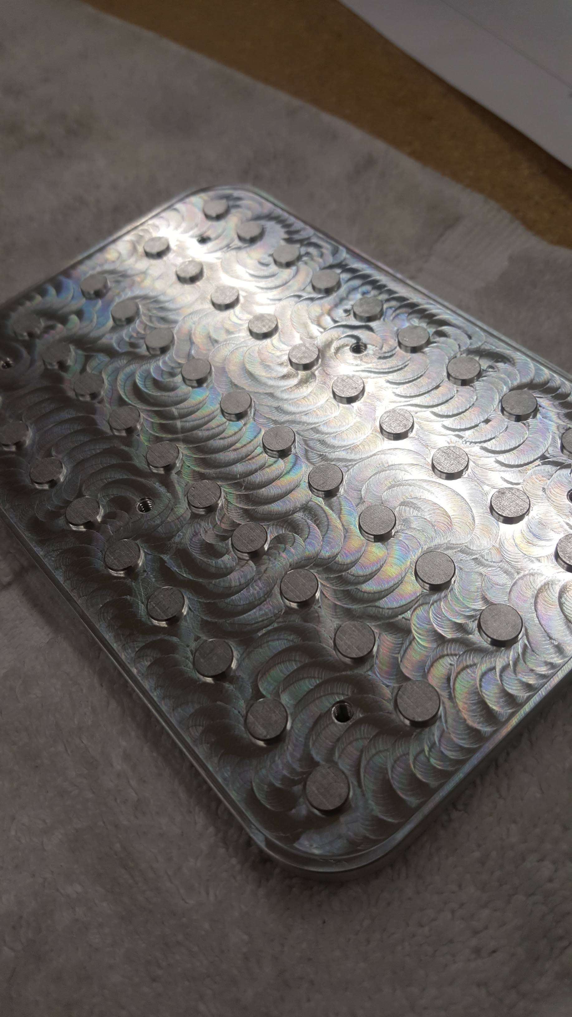 A metal tray with holes in it is sitting on a table.