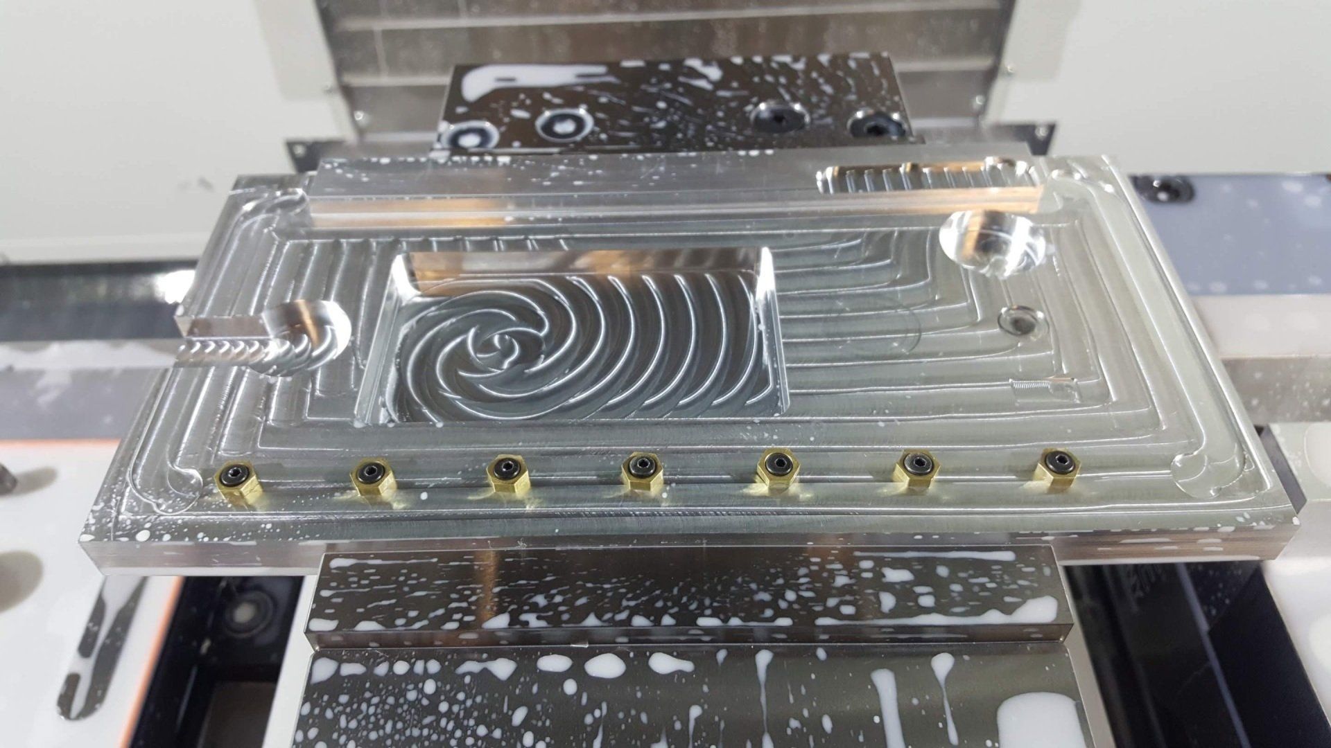 A piece of metal is sitting on top of a machine.