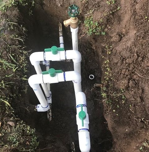 Person Repairing Water Sprinkler — Temecula, California — Joseph's Landscape Co. Inc. Person Repairing Water Sprinkler — Temecula, California — Joseph's Landscape Co. Inc.