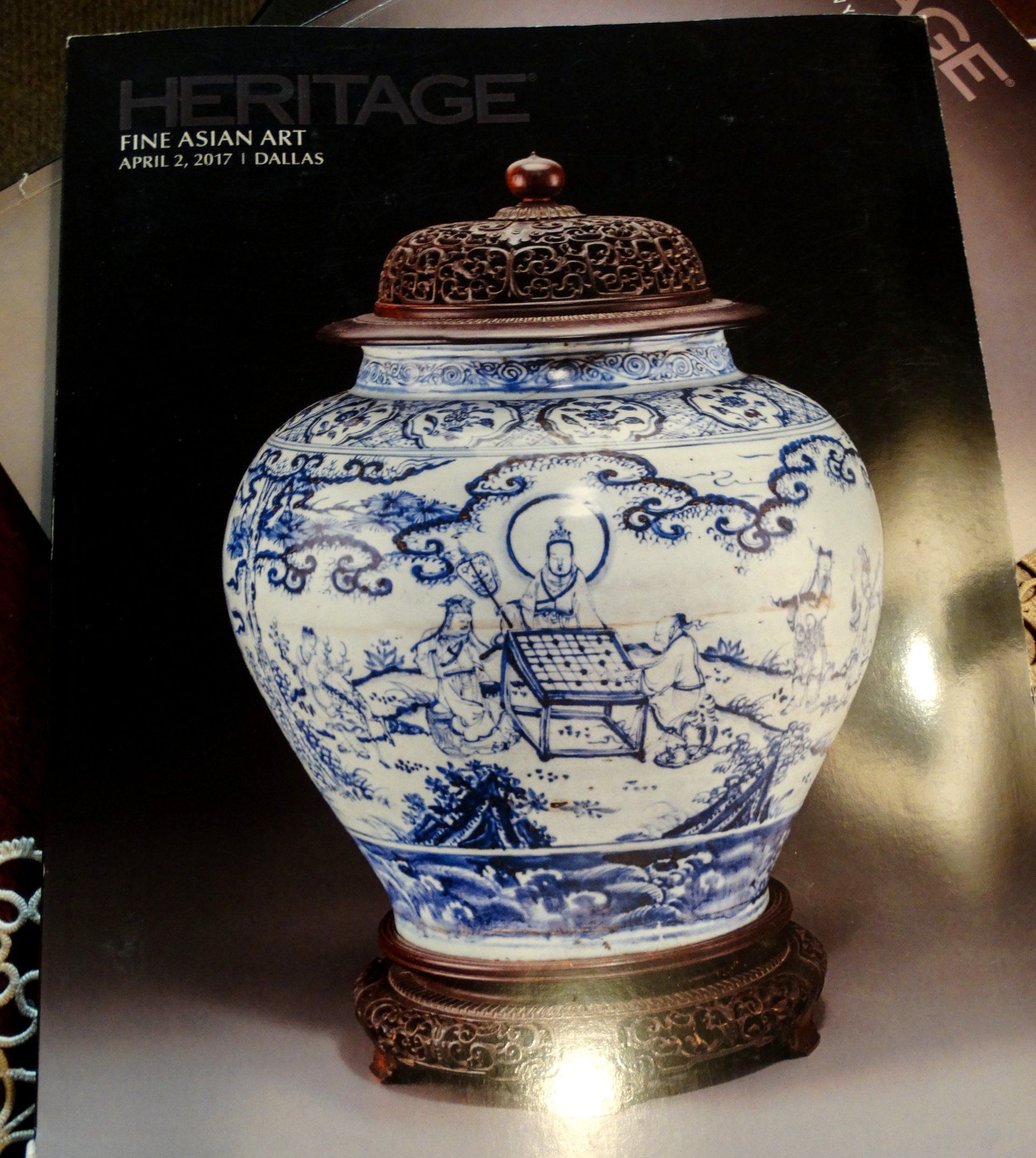 A blue and white vase is on the cover of a magazine called heritage