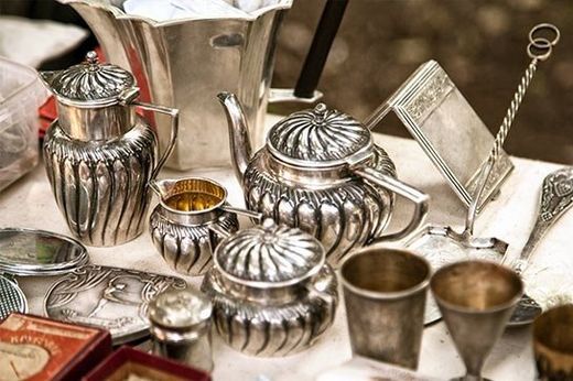 Antiques — Silver Items in Eugene, OR A table topped with a variety of silver objects.