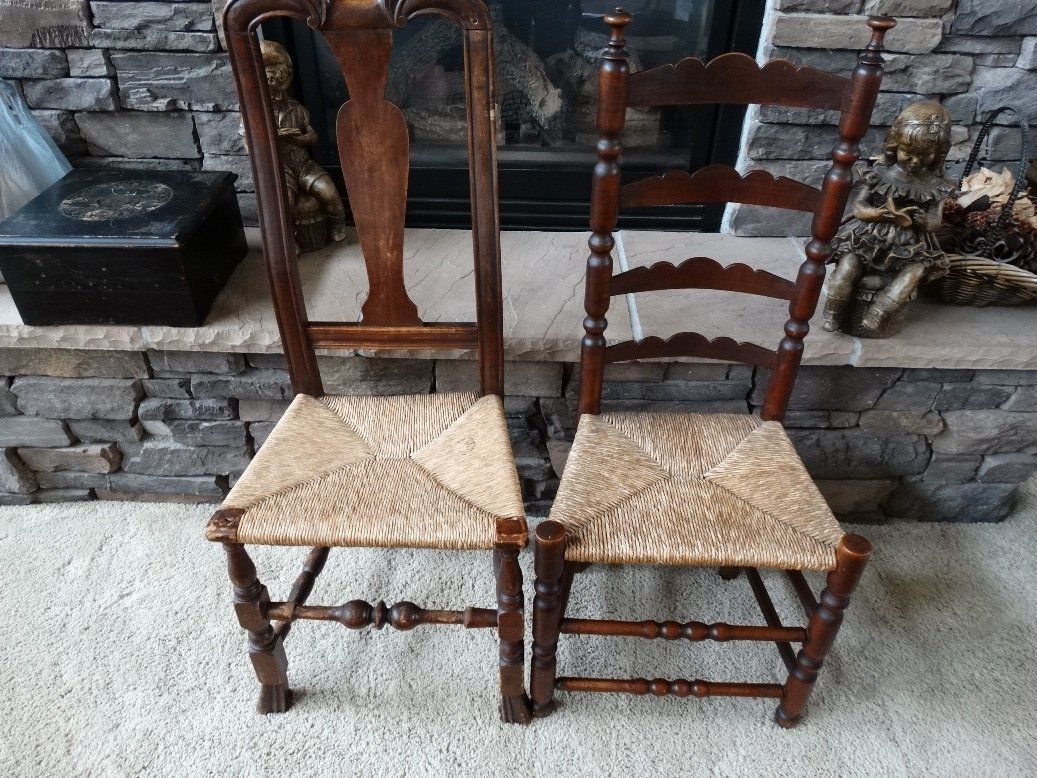 Two chairs are sitting next to each other in front of a fireplace