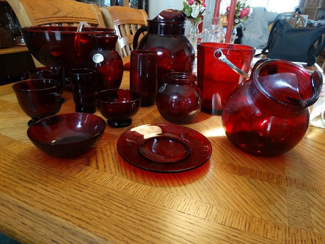 A table with a lot of red glassware on it