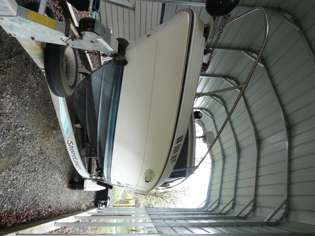 A boat is sitting inside of a metal building