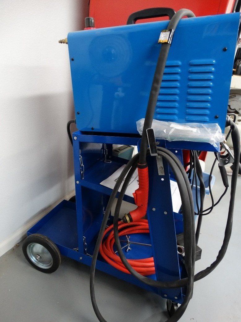A blue cart with a welding machine attached to it
