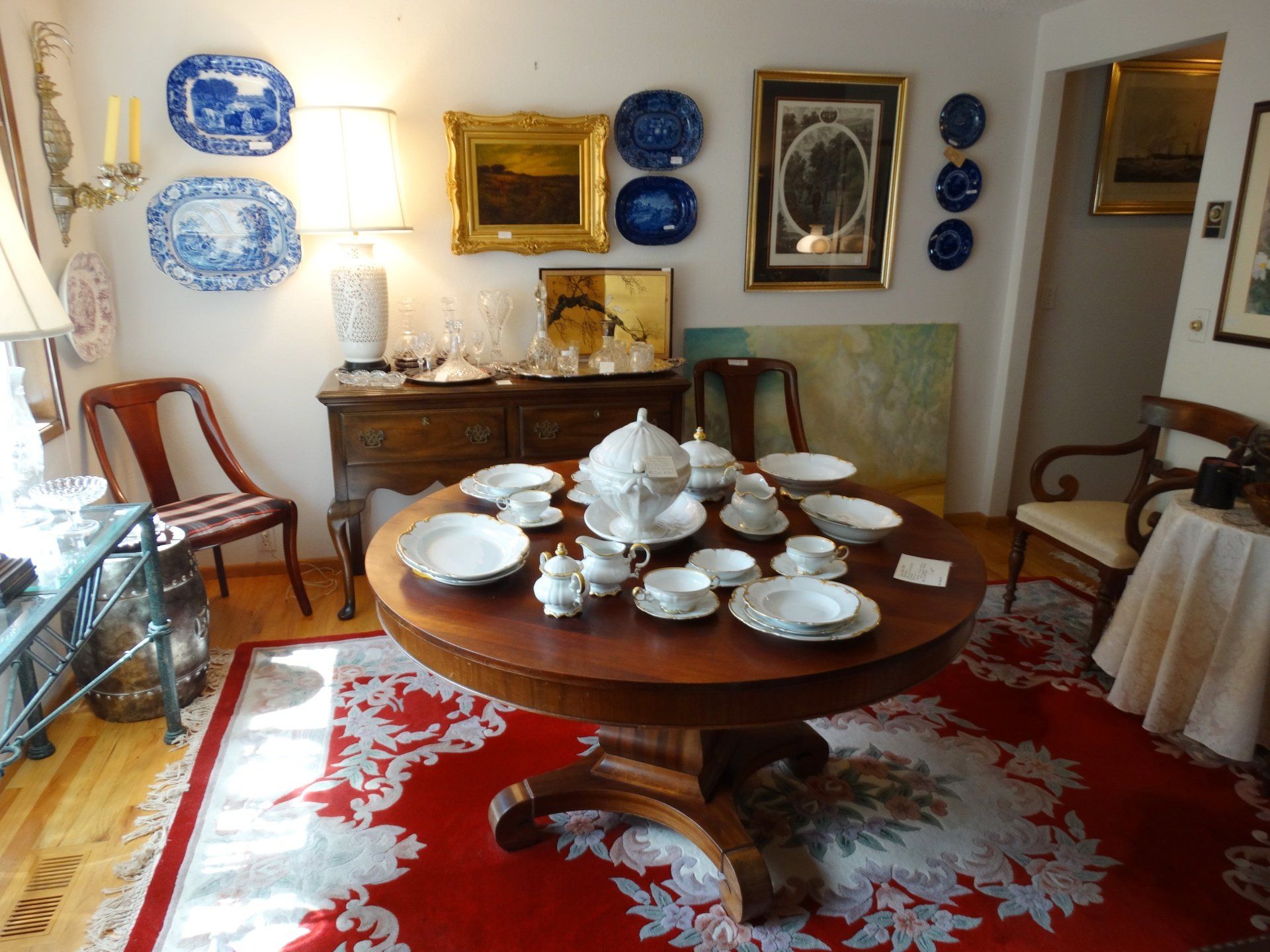 A dining room with a round table and plates on it