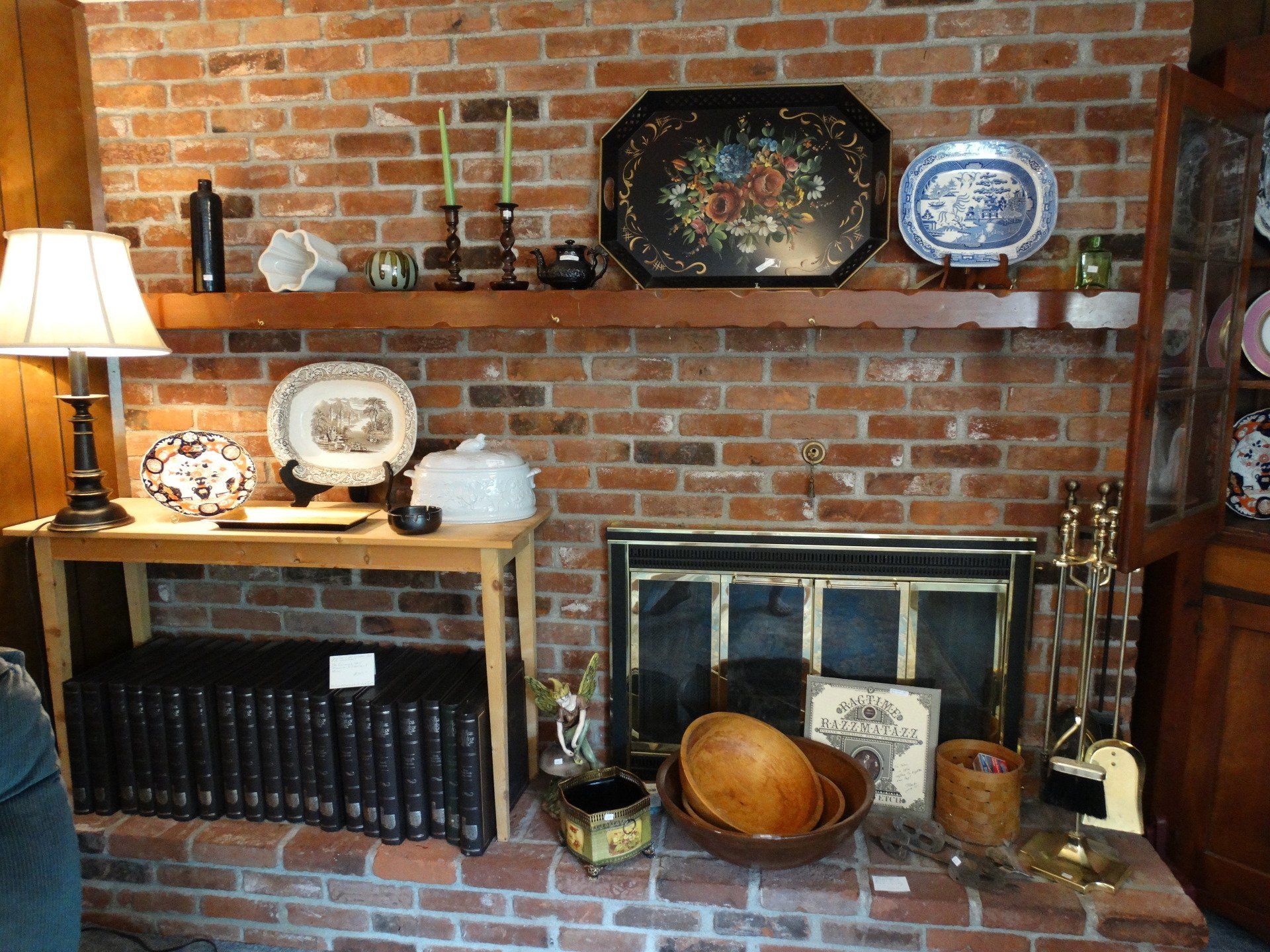 A living room with a brick wall and a fireplace