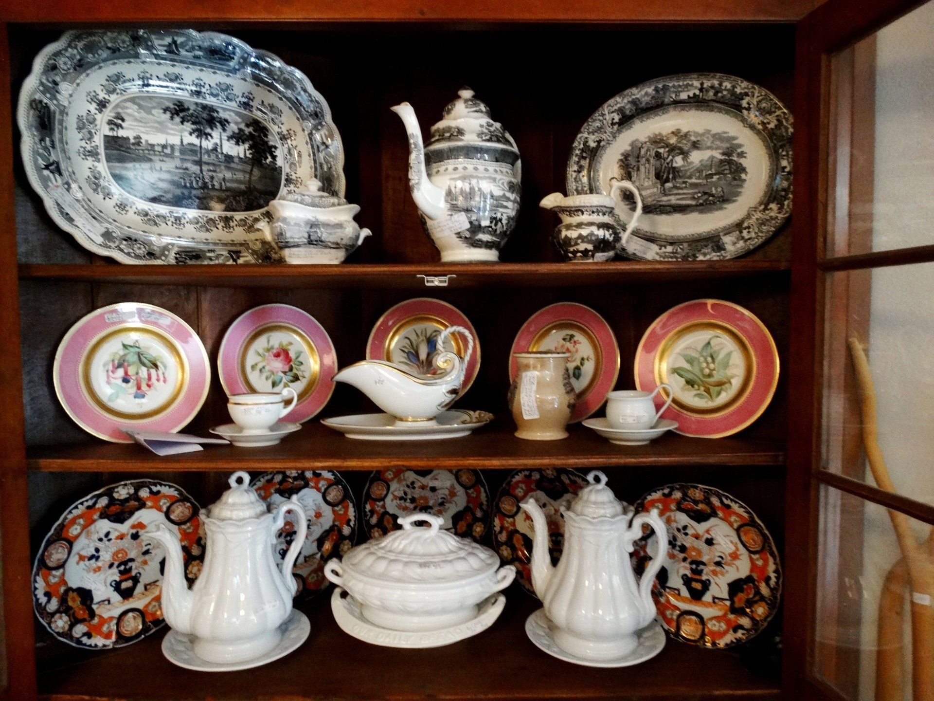 A display case filled with plates and teapots