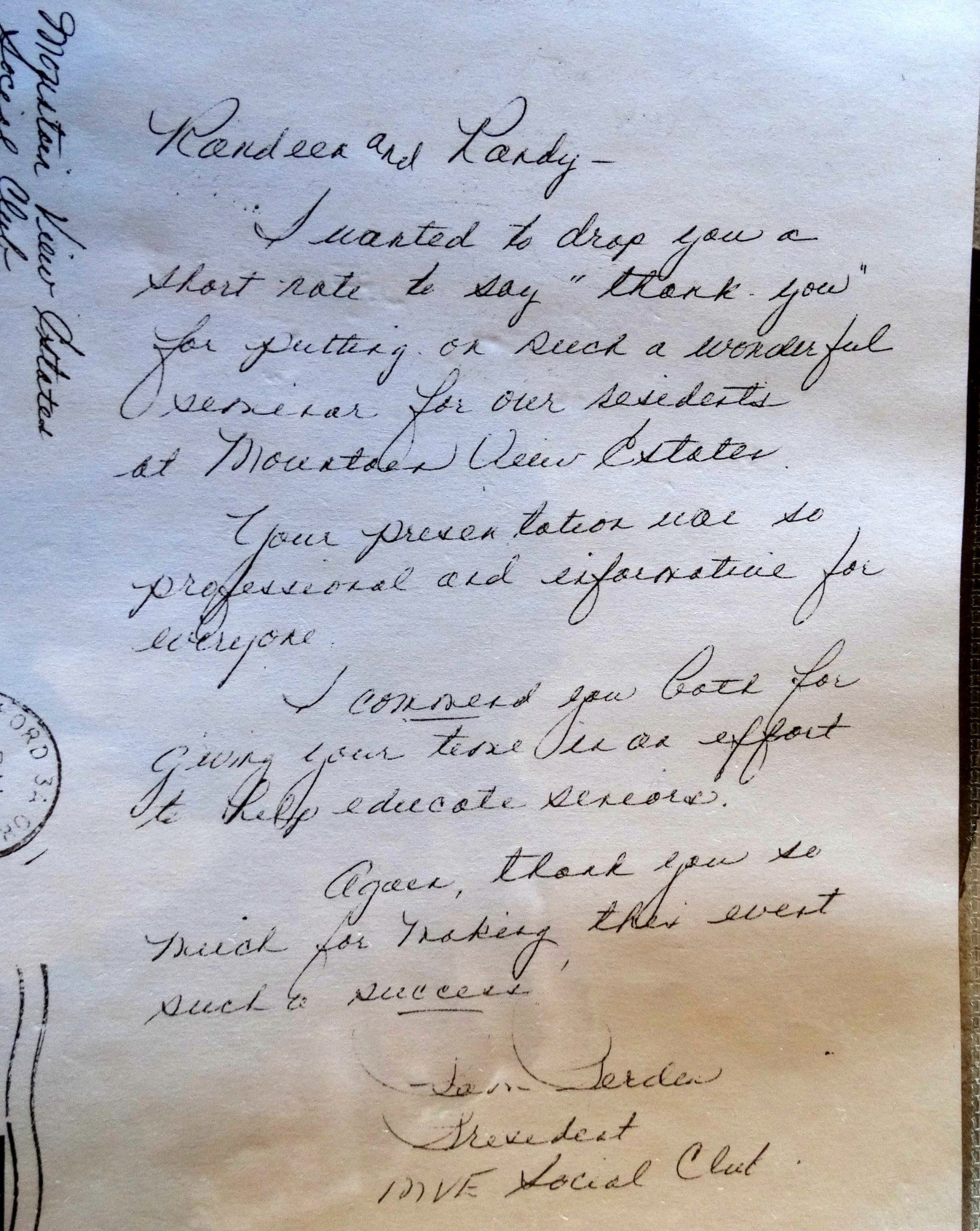 A letter is written in cursive on a piece of paper