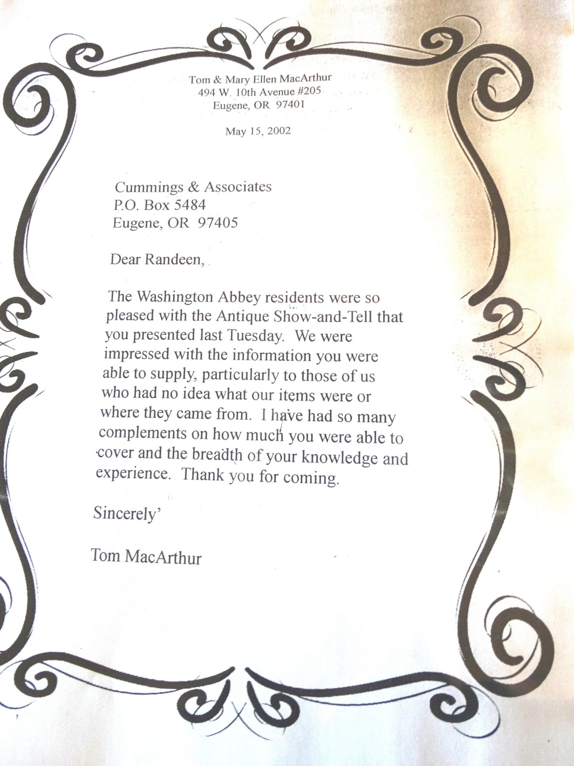 A letter with a black and white frame and swirls on it.