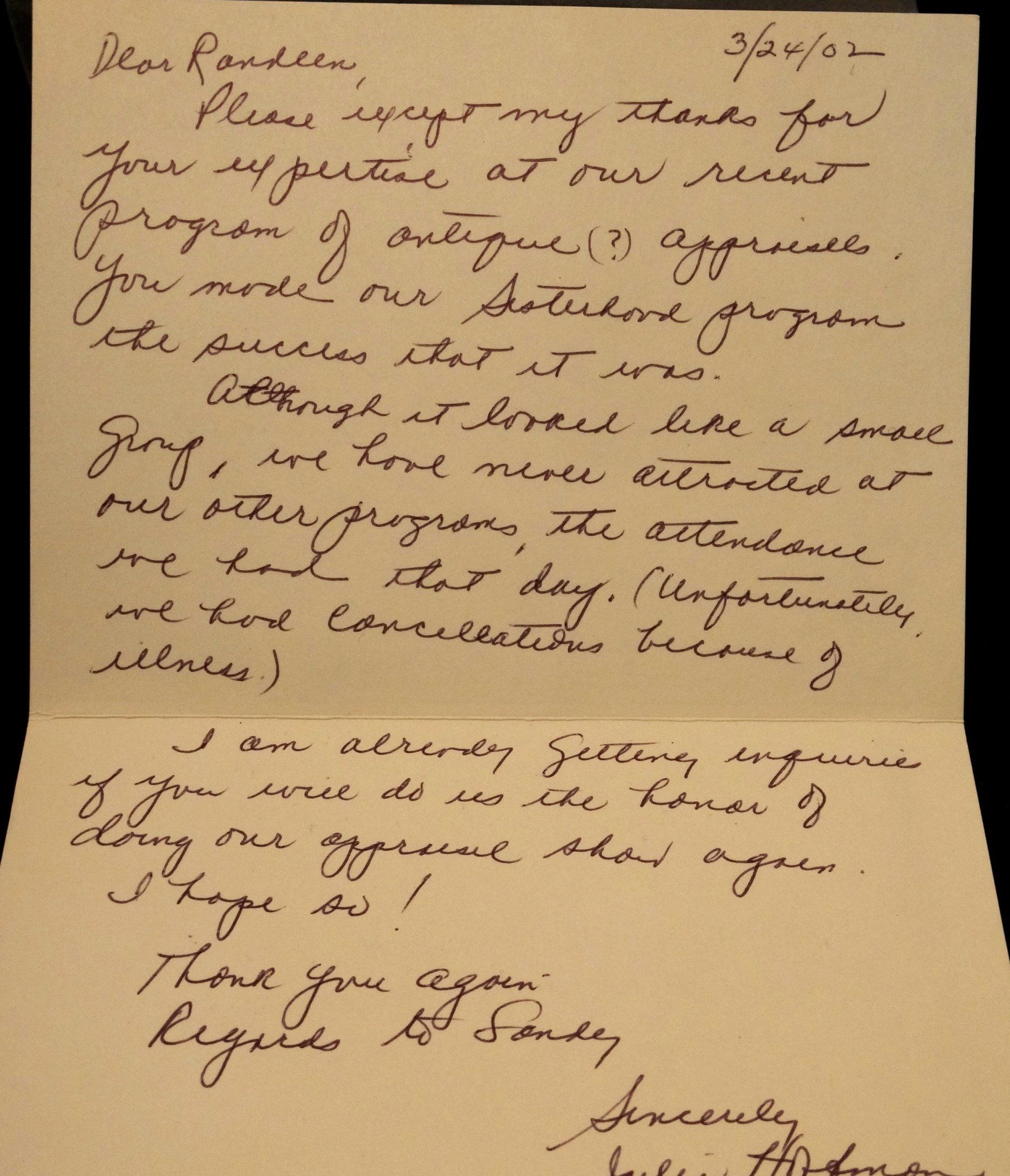 A handwritten letter is open to a page that says 