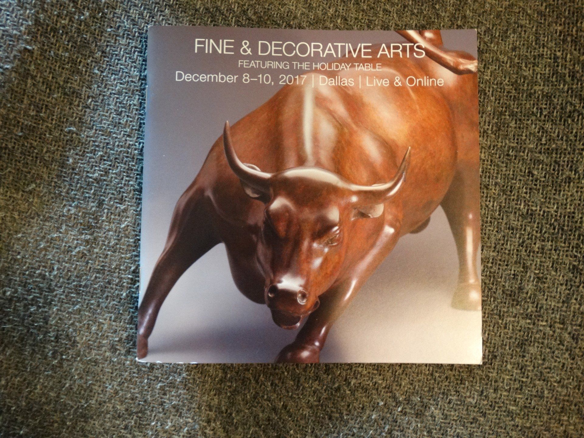A poster for fine and decorative arts features a statue of a bull