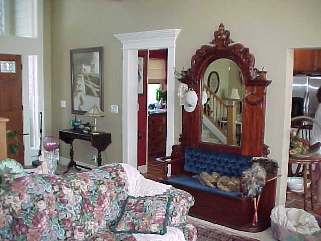 A living room with a couch and a mirror