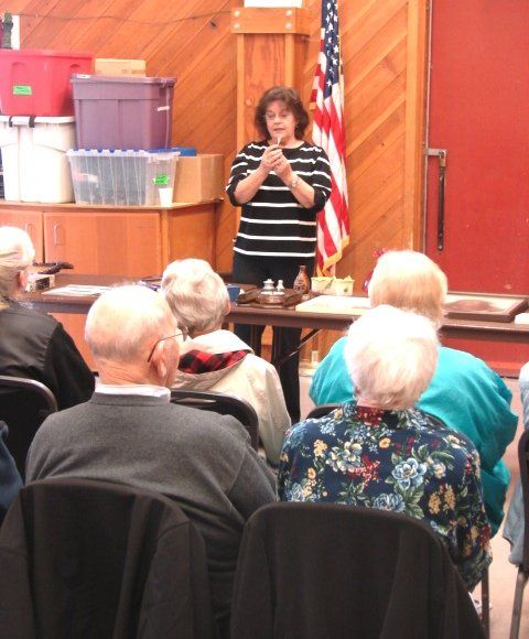 A woman is giving a presentation to a group of people