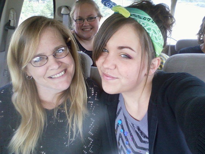 Two women are posing for a picture in a car
