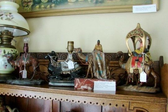 Garage Sales — Garage Sale Sign in Eugene, OR A shelf with statues of camels and a lamp on it