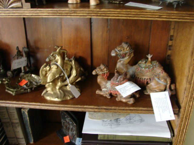 A wooden shelf with a bunch of statues on it