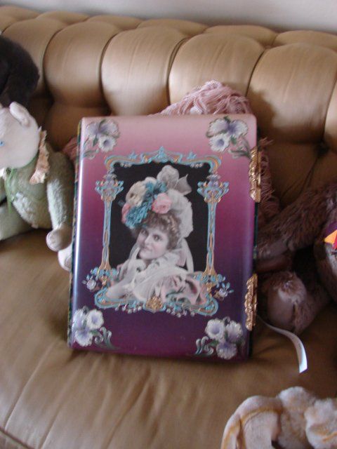 A picture of a woman in a hat is on a couch
