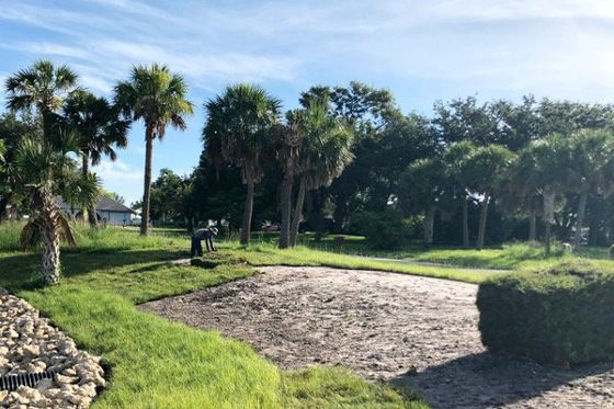 Worker laying sod — Palm City Sod in Palm City, FL Worker laying sod — Palm City Sod in Palm City, FL