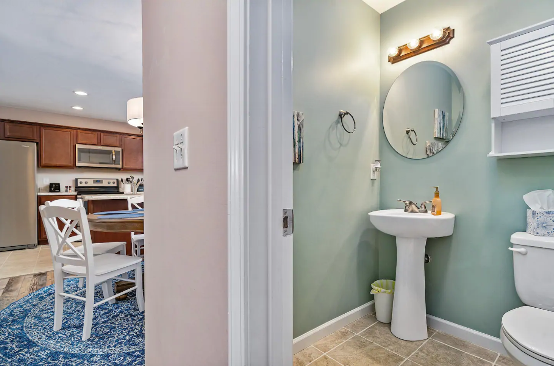 A bathroom with a sink , toilet and mirror.