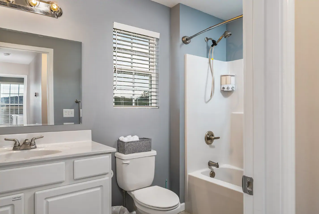 A bathroom with a toilet , sink , and bathtub.