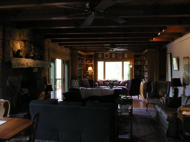 A living room filled with furniture and a ceiling fan