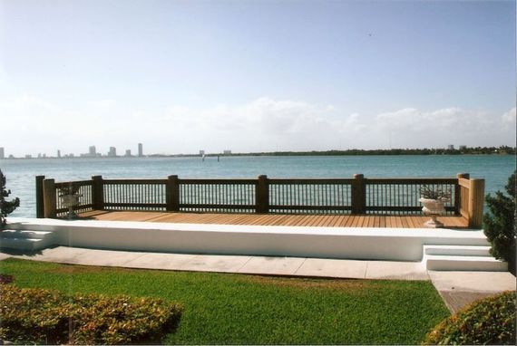 Wooden Deck Installation — Brown Wooden Post With Flower Pot in Miami, FL Wooden Deck Installation — Brown Wooden Post With Flower Pot in Miami, FL