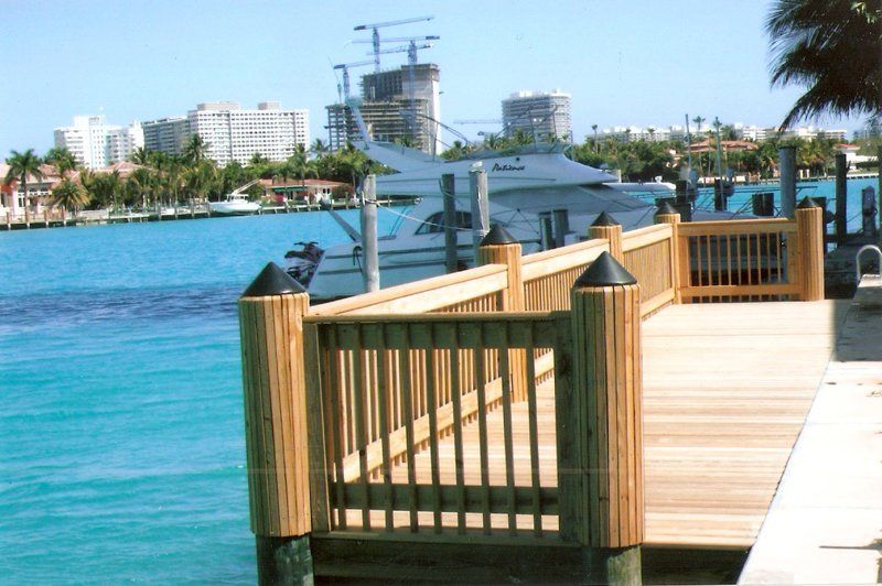 Wooden Deck — Brown Deck With White Boat in Miami, FL