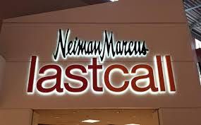A sign for neiman marcus lastcall is lit up at night.