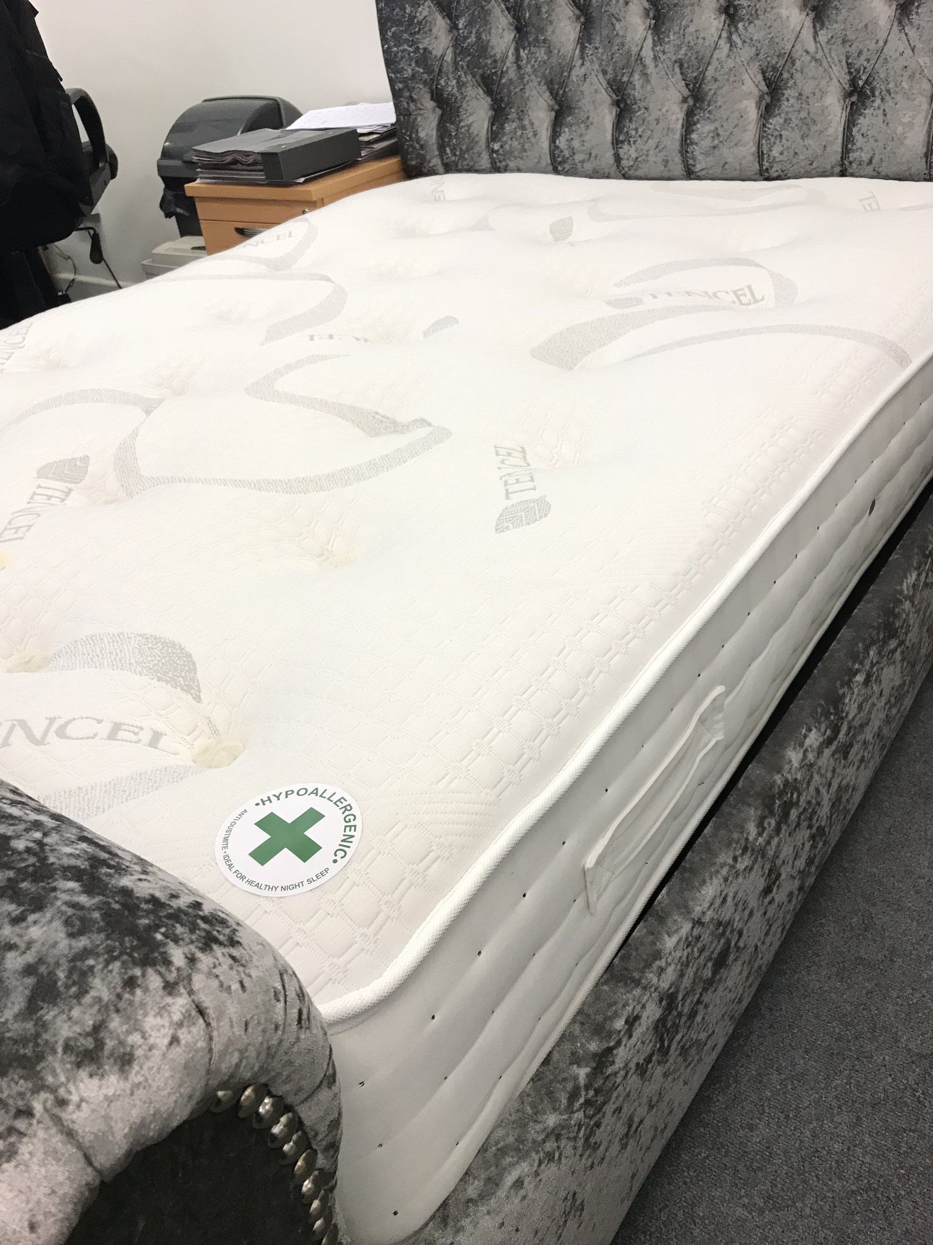 A white mattress with a green cross on it