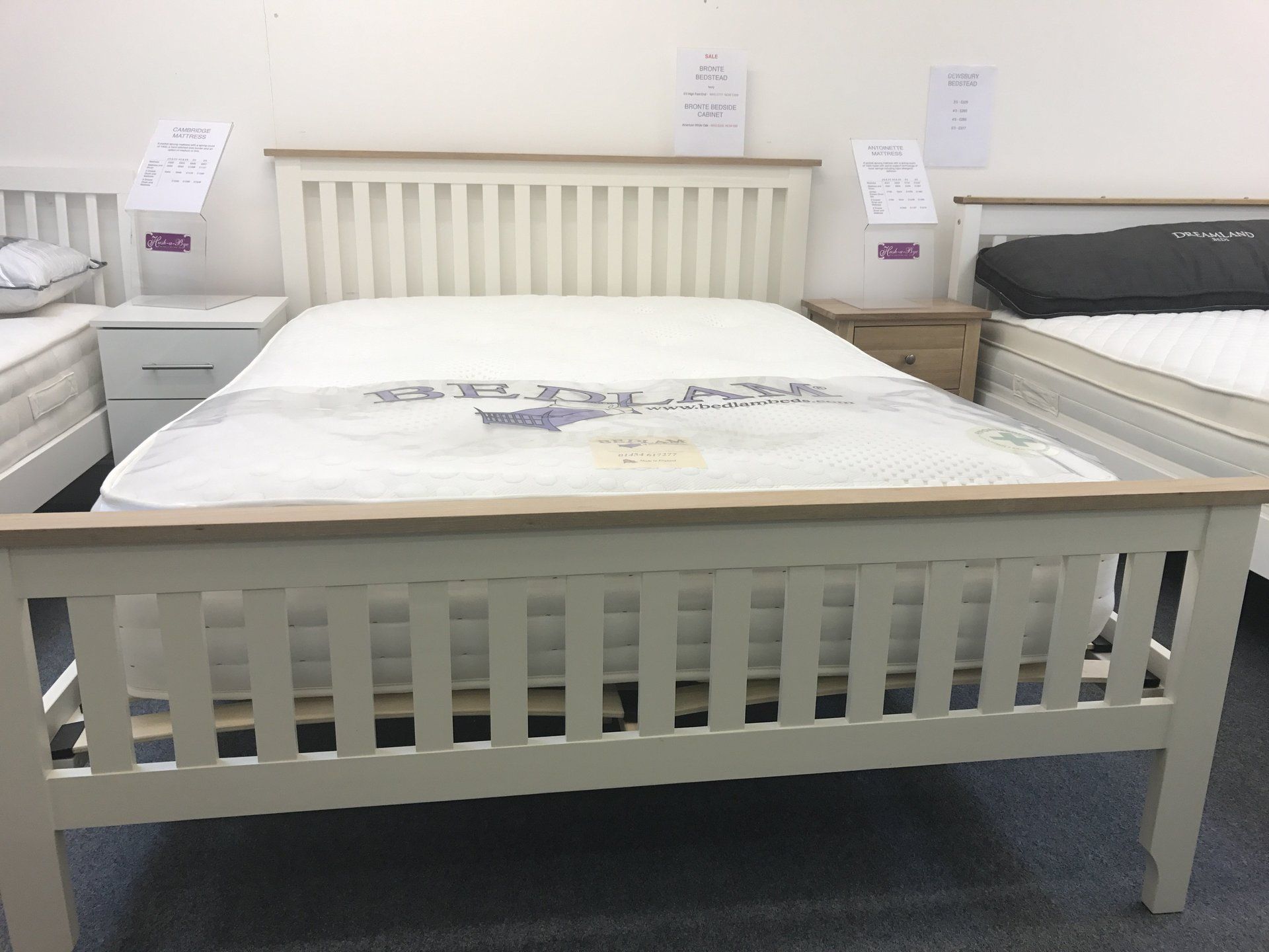 A bed with a mattress on top of it in a store.