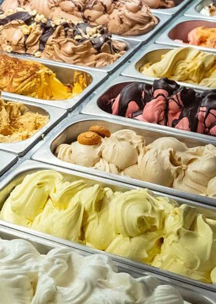 There are many different flavors of ice cream in the trays.