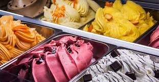 There are many different flavors of ice cream in the trays.