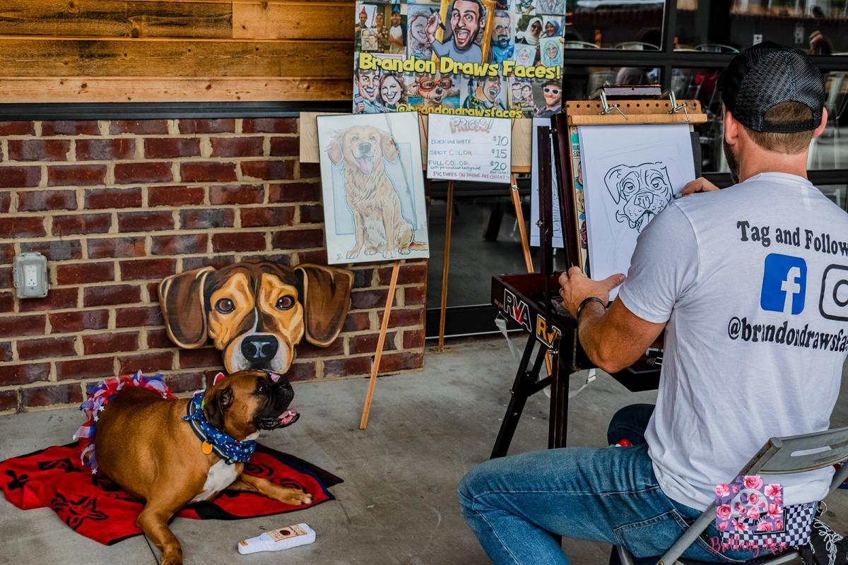 A man is painting a picture of a dog on an easel.