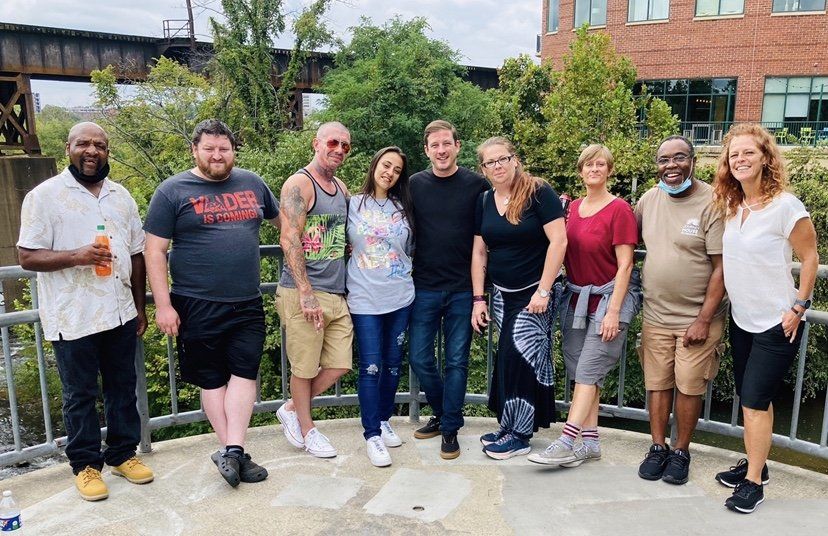 A group of people are posing for a picture on a bridge.