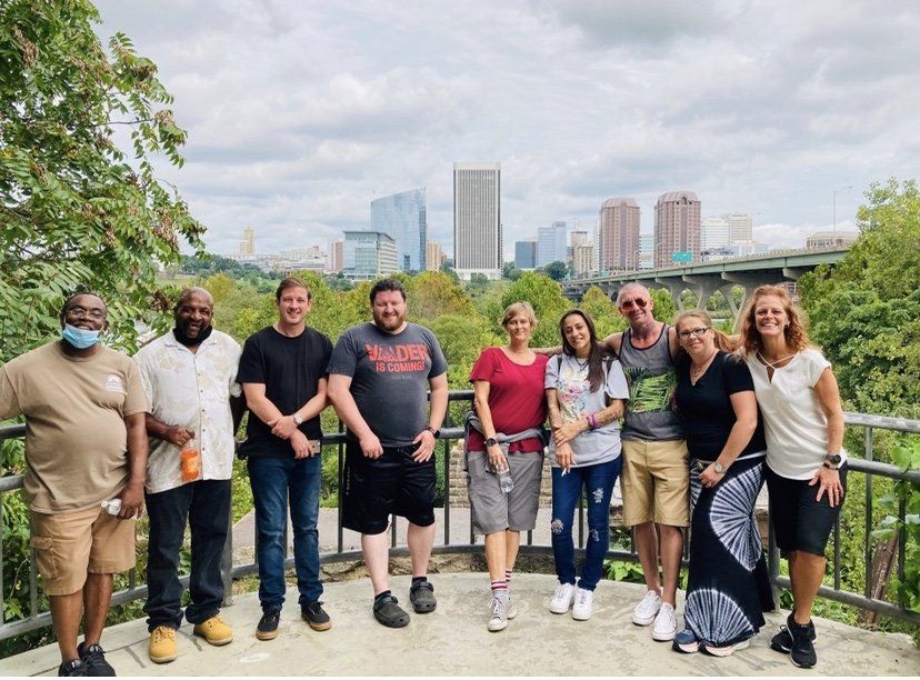 A group of people are posing for a picture in front of a city skyline.