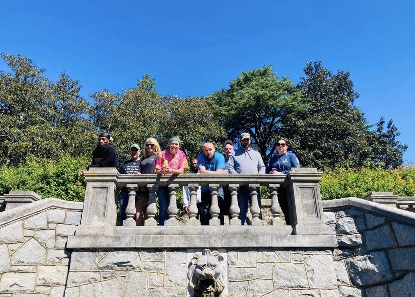 A group of people are posing for a picture on a balcony.