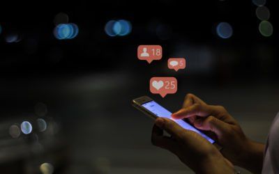 A person is using a cell phone in the dark.