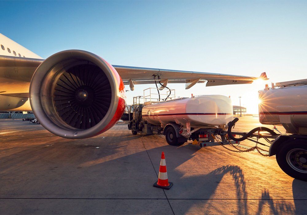 Amazing sunset at the airport. Refueling of the airplane before flight
