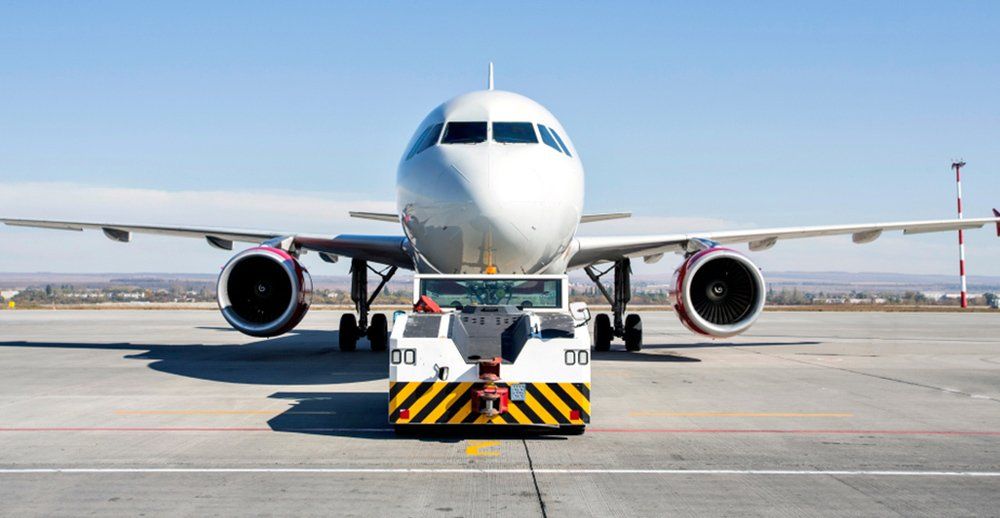 the plane with the airfield tractor