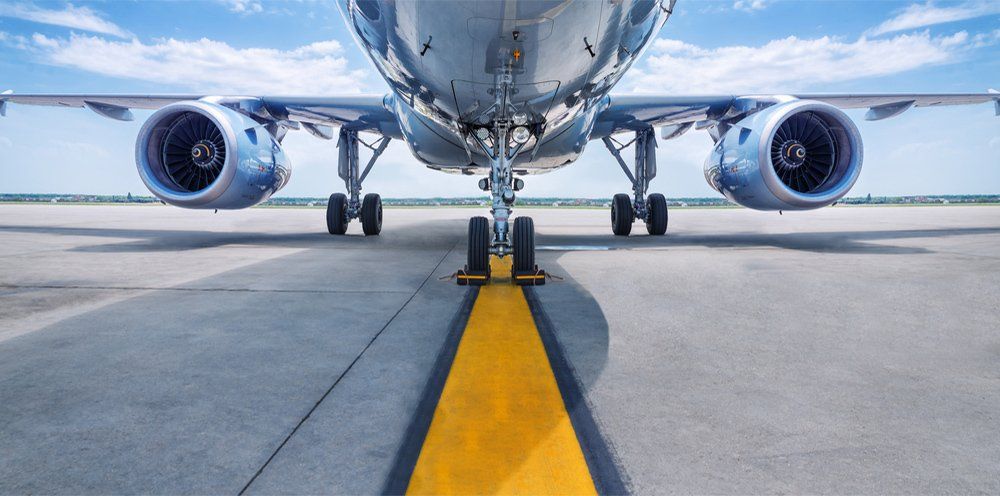 Brand New Airplane Standing in a Aircraft Maintenance Hangar while Aircraft Maintenance Engineer-Technician-Mechanic goes inside Cabin via Ladder-Ramp