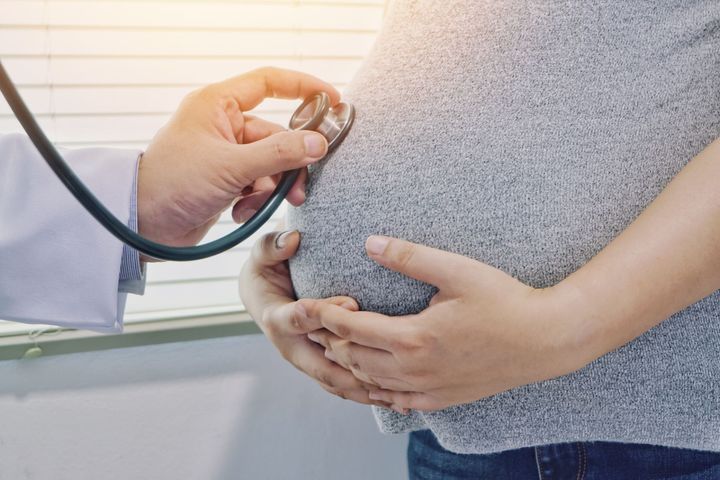 Doctor examining pregnant woman