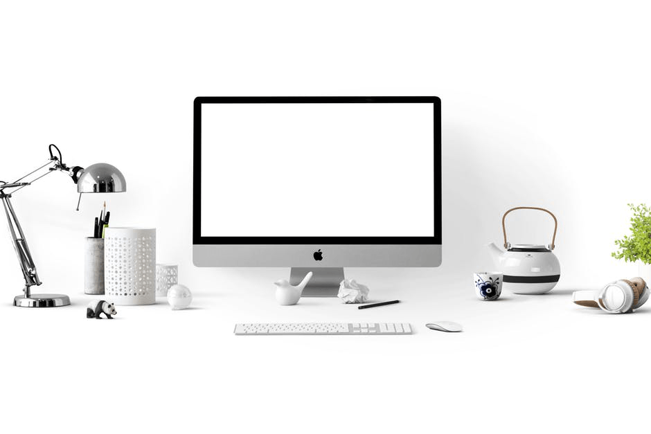 a computer with a white screen is sitting on a desk