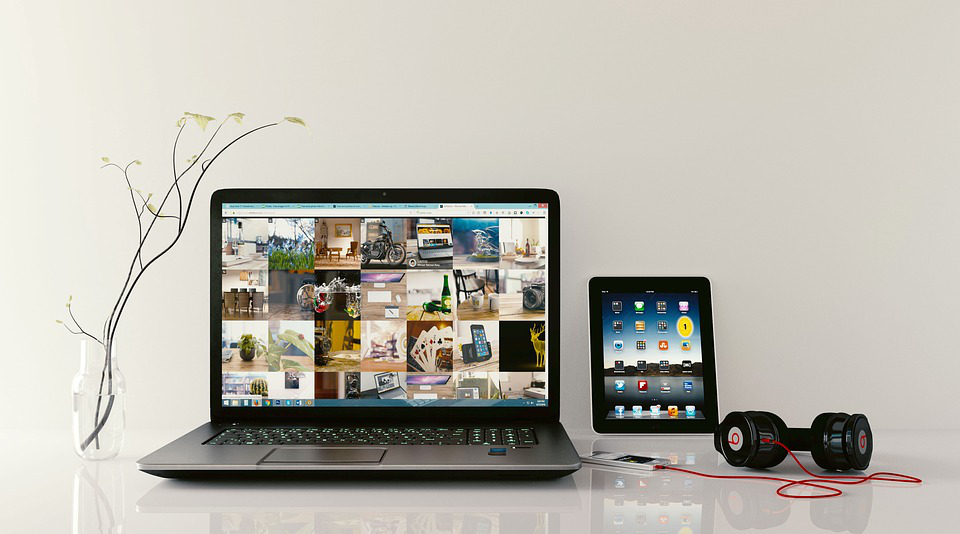 a laptop and a tablet are on a table