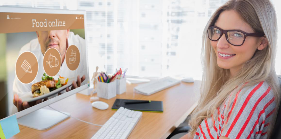 a woman is sitting at a desk in front of a computer screen that says food online