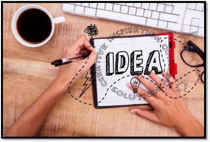 a person is writing the word idea on a clipboard