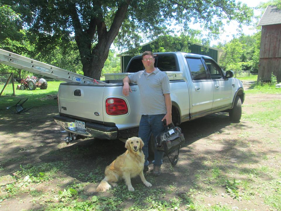 person standing at truck with dog