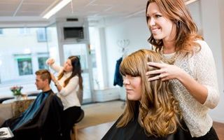 Woman at beauty salon showing her client — Hair salon at Altoona, PA