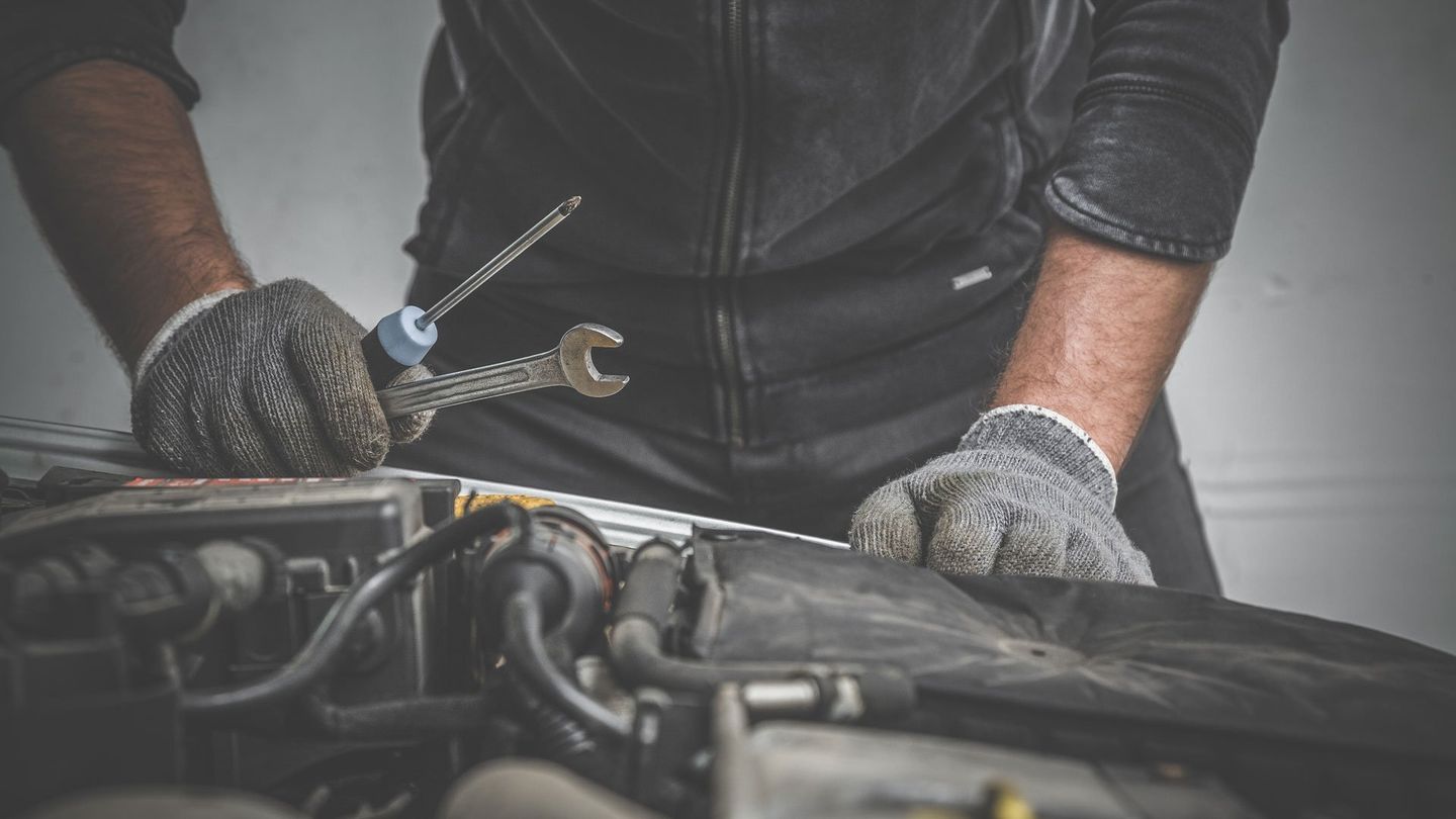 Mechanic Holding Tools — Oklahoma City, OK — Super Quick Express Lube Mechanic Holding Tools — Oklahoma City, OK — Super Quick Express Lube