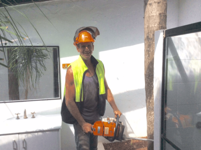 Arborist Holding a Chainsaw — Tree Services Lismore, NSW Arborist Holding a Chainsaw — Tree Services Lismore, NSW